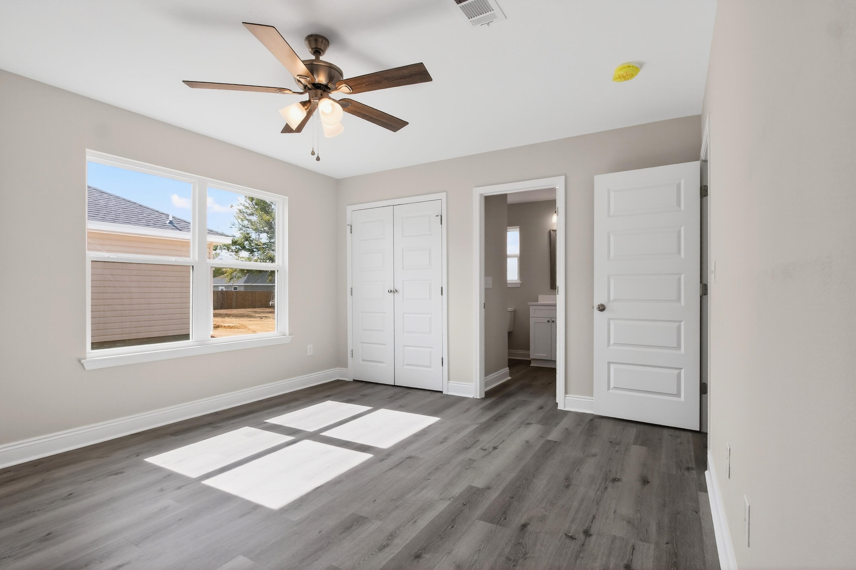 5358 Highview Drive Crestview, FL 32539 - Photo 18 of 31 wooden floor in an empty room with a window