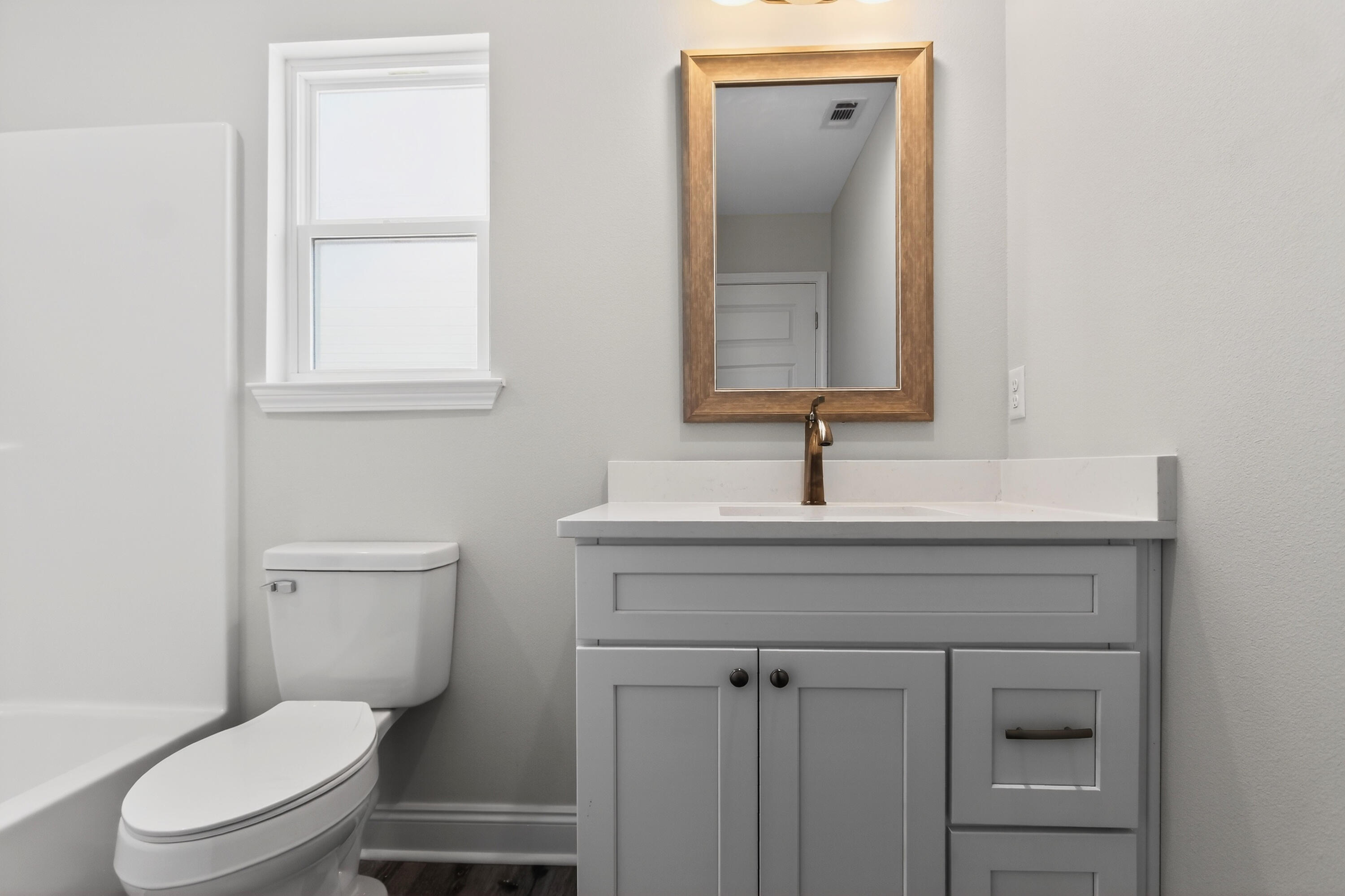5358 Highview Drive Crestview, FL 32539 - Photo 20 of 31 a bathroom with a toilet a sink a vanity and mirror