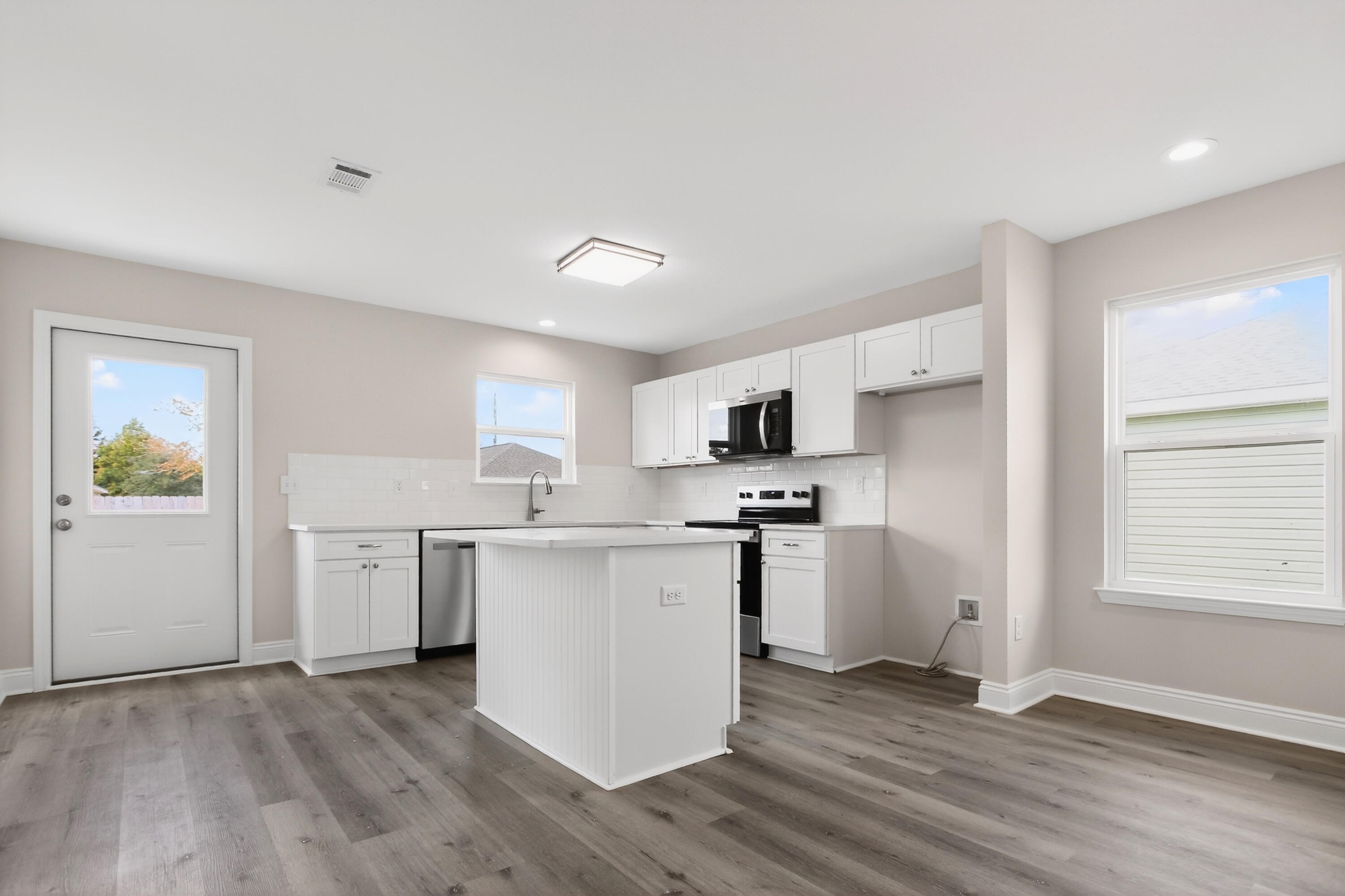 5358 Highview Drive Crestview, FL 32539 - Photo 6 of 31 a kitchen with stainless steel appliances a sink a stove a refrigerator cabinets and a window
