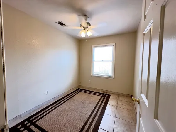 a view of a room with window and ceiling fan