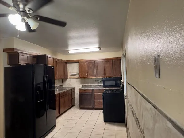 a kitchen with a refrigerator and a sink