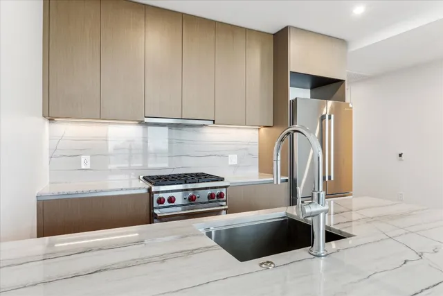 a kitchen with granite countertop a refrigerator and a stove
