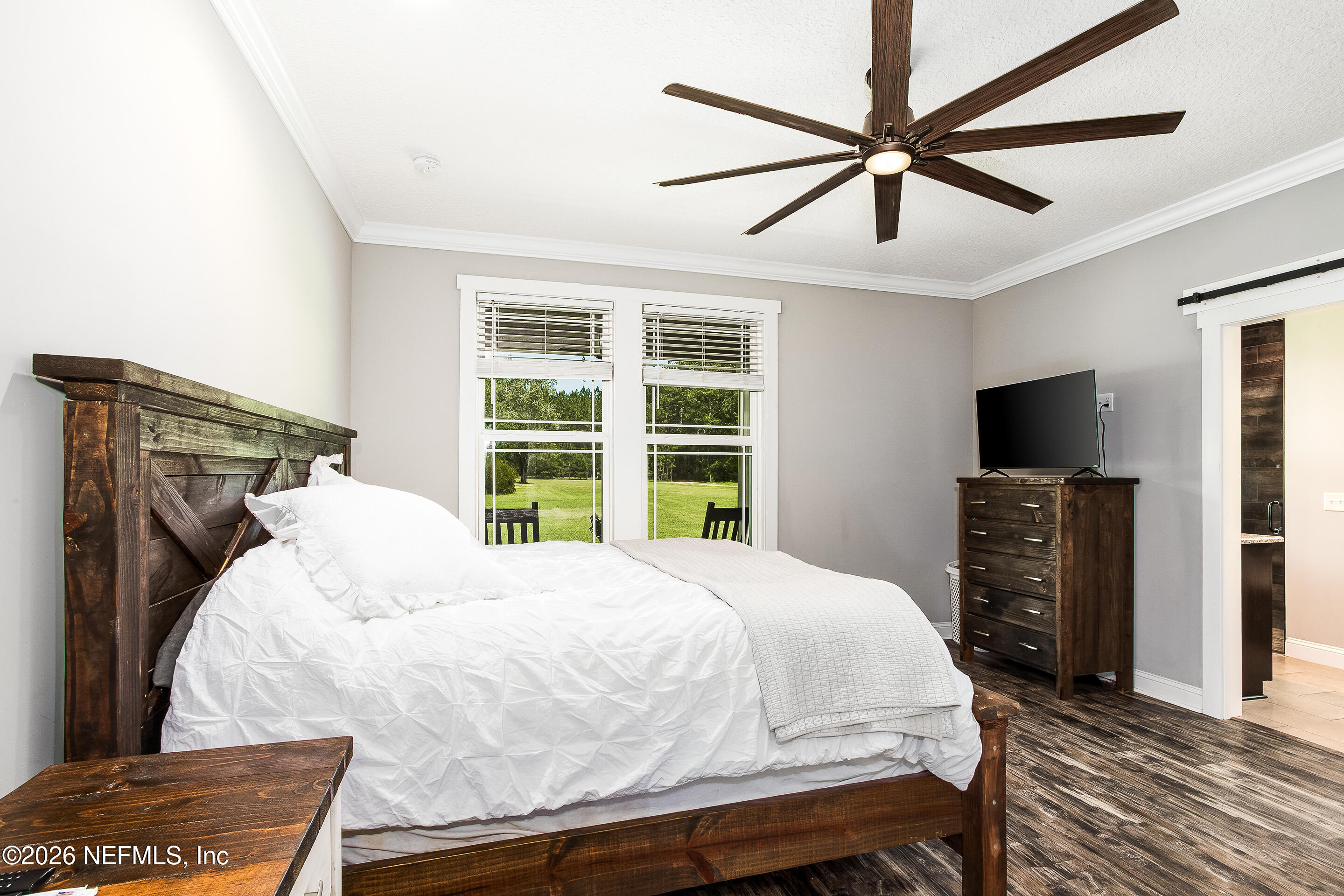 26575 Sheared Stokes Road Hilliard, FL 32046 - Photo 13 of 39 a bedroom with a bed and a flat screen tv
