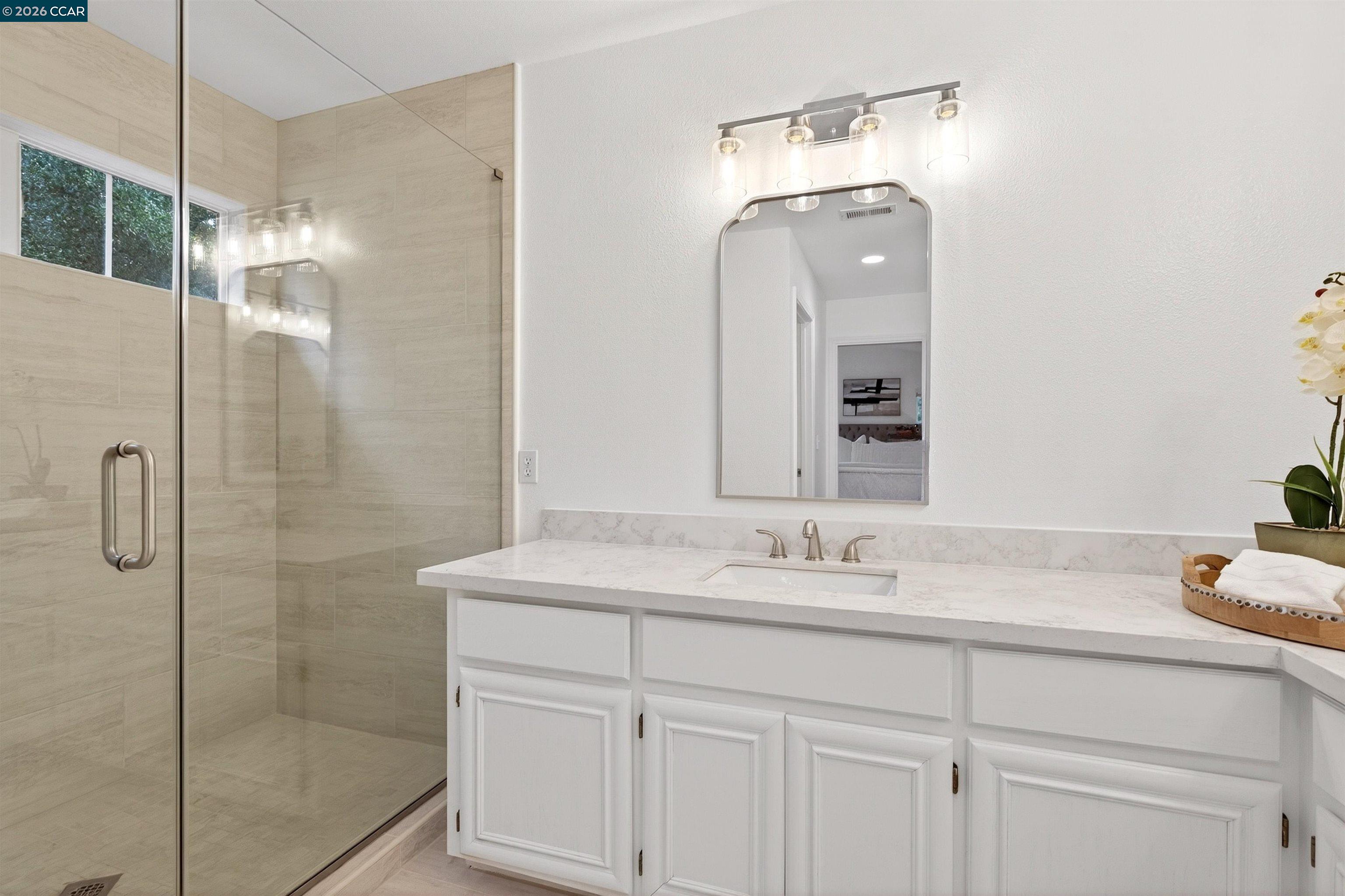 124 Coralflower Lane San Ramon, CA 94582 - Photo 18 of 47 a bathroom with a sink a shower and a mirror