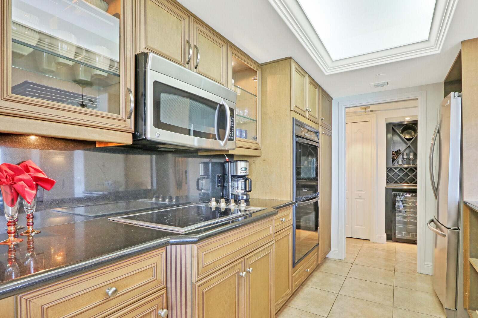 4100 North Ocean Drive, Unit 503 Singer Island, FL 33404 - Photo 19 of 51 a kitchen with stainless steel appliances granite countertop a sink and cabinets