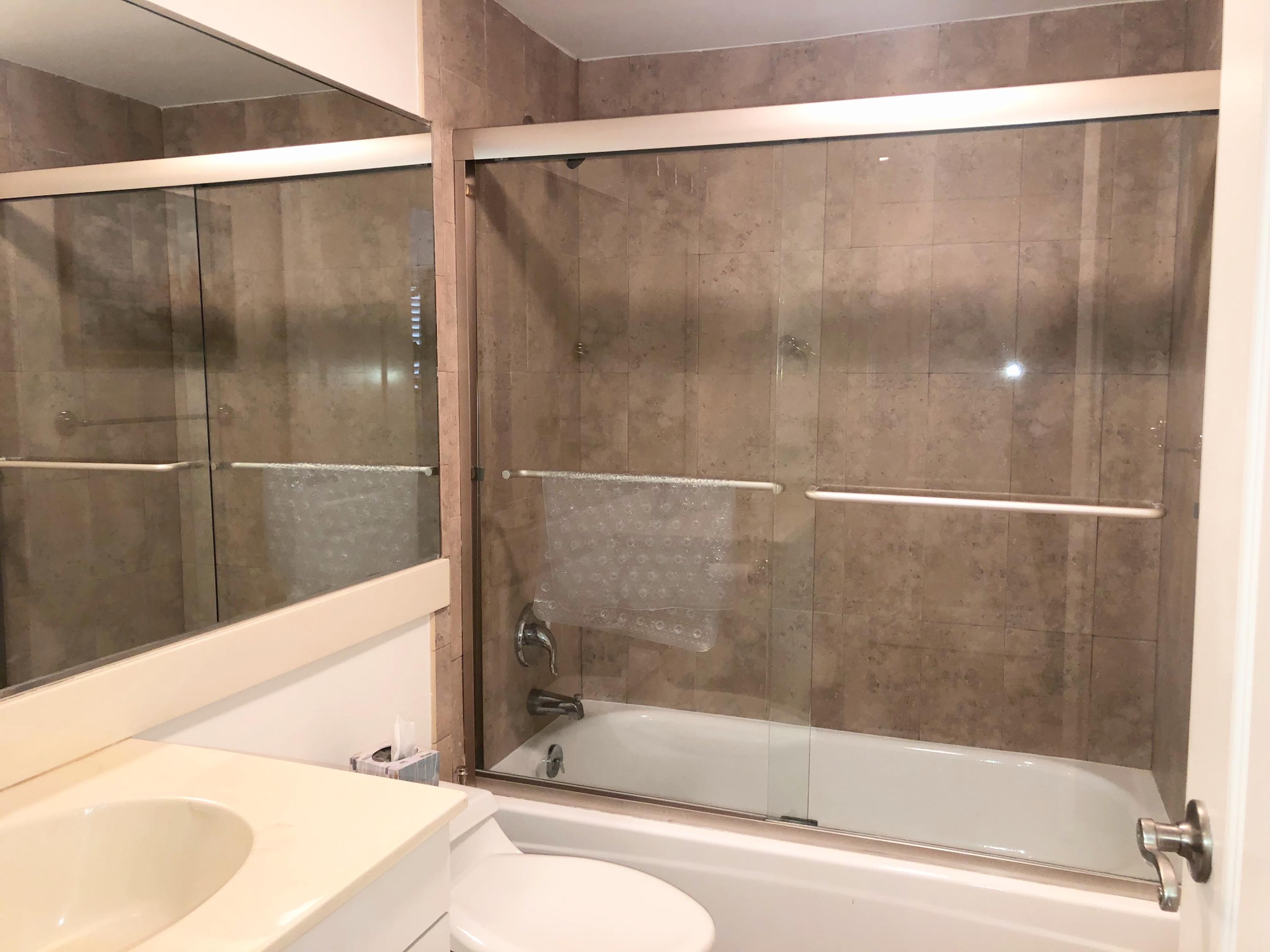 4100 North Ocean Drive, Unit 503 Singer Island, FL 33404 - Photo 29 of 51 a bathroom with a bathtub and a shower