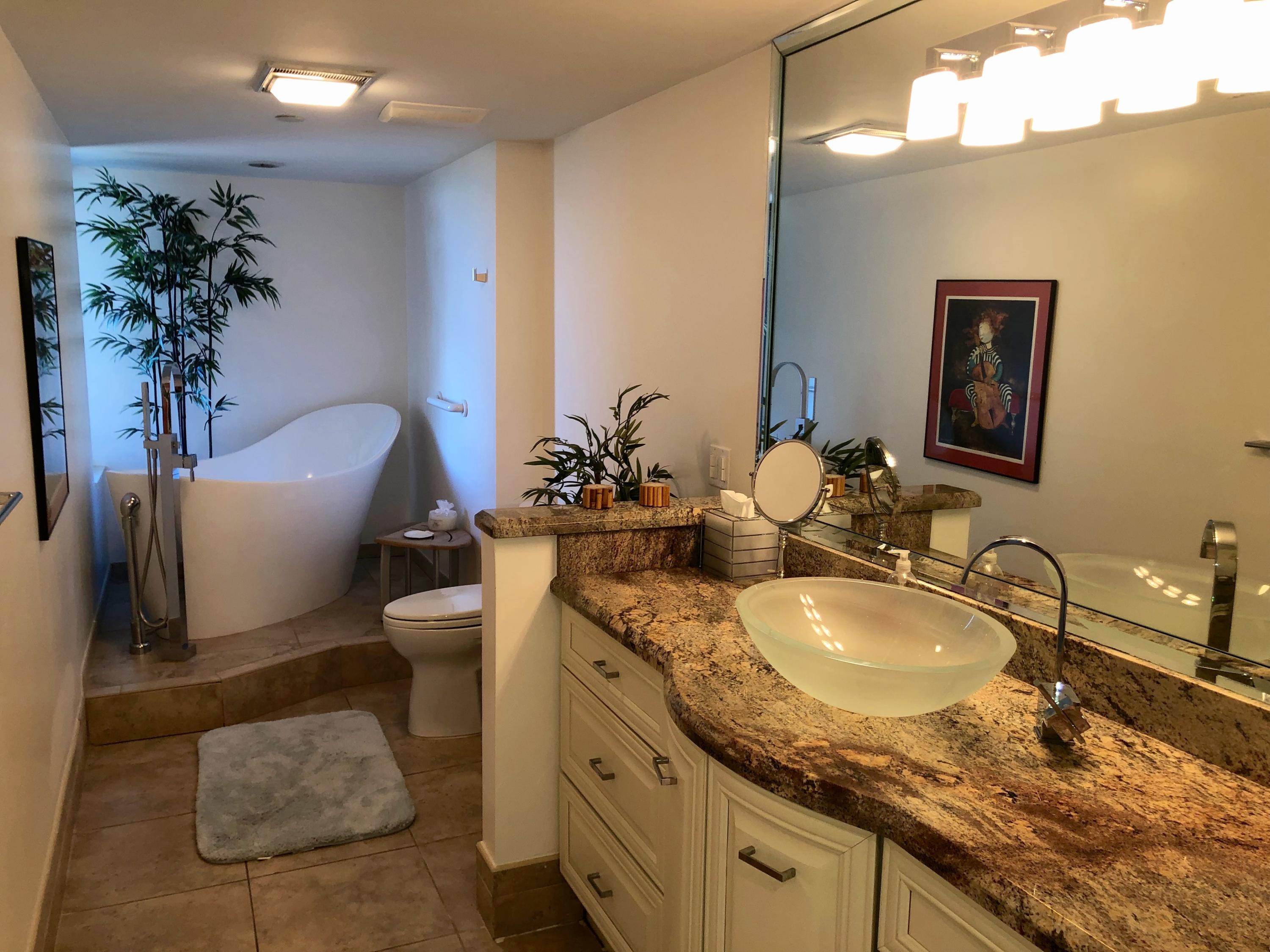 4100 North Ocean Drive, Unit 503 Singer Island, FL 33404 - Photo 31 of 51 a bathroom with a granite countertop sink a toilet and a mirror