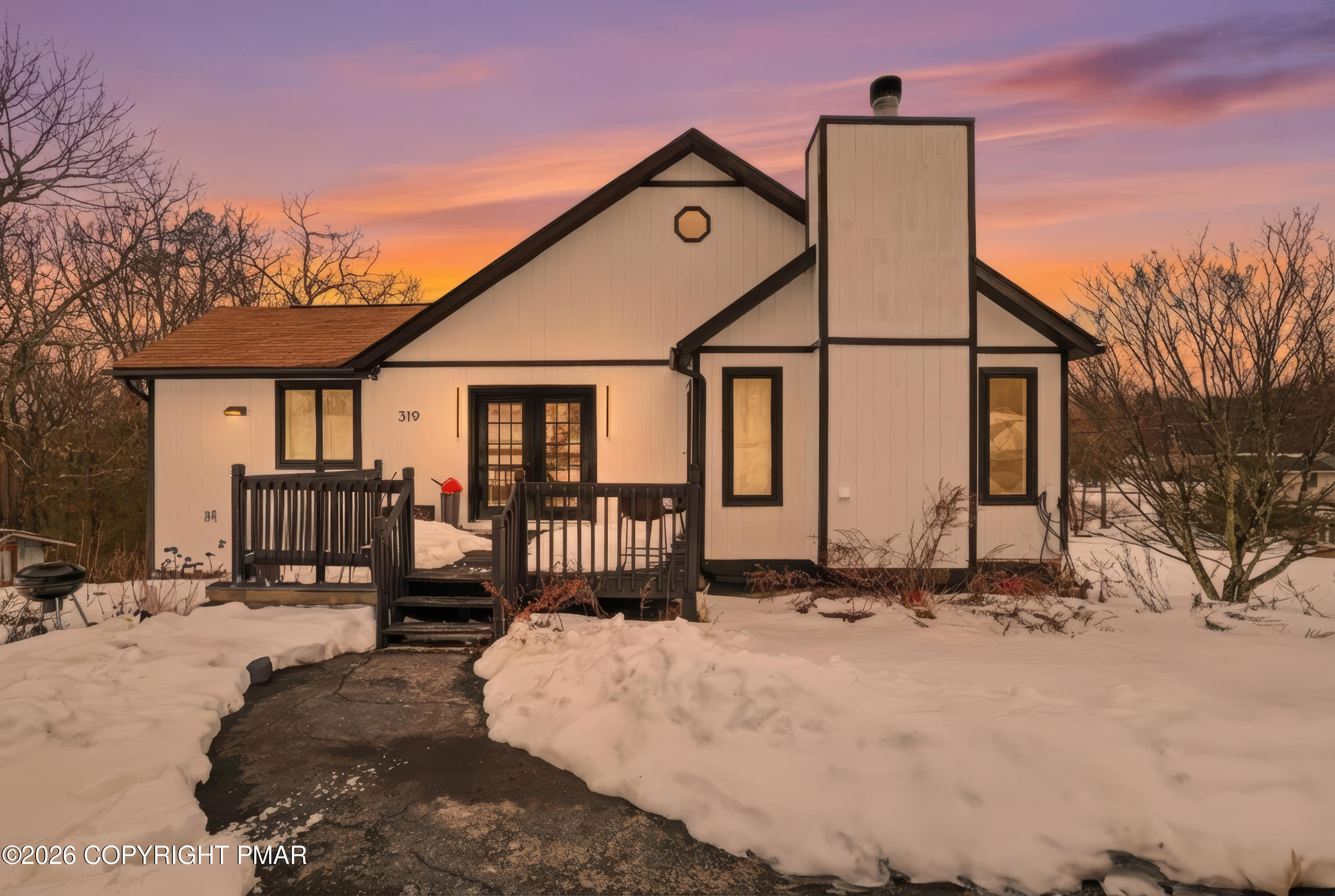 a front view of a house with large windows