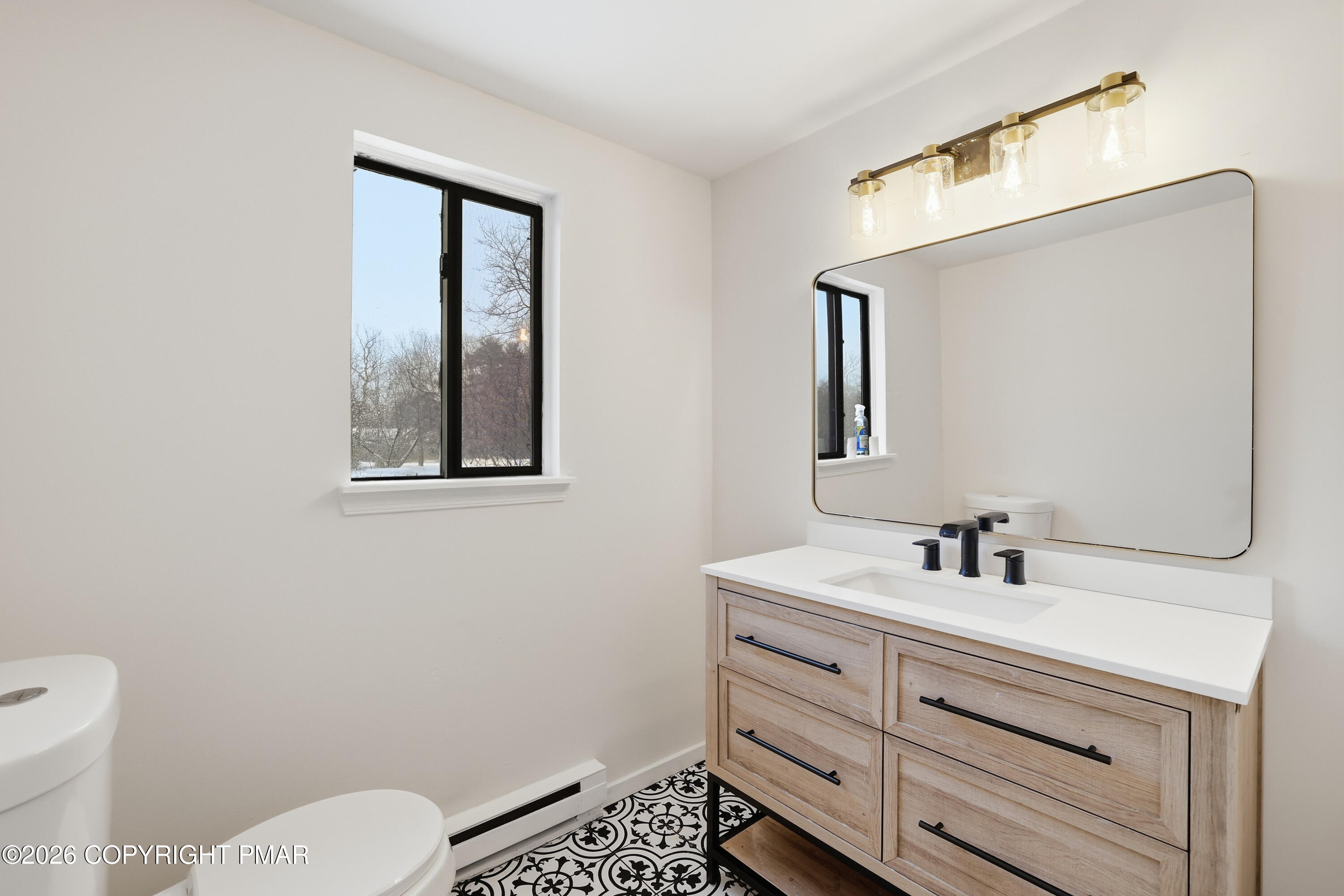 319 Ramble Bush Road Stroudsburg, PA 18360 - Photo 19 of 51 a bathroom with a toilet sink and mirror