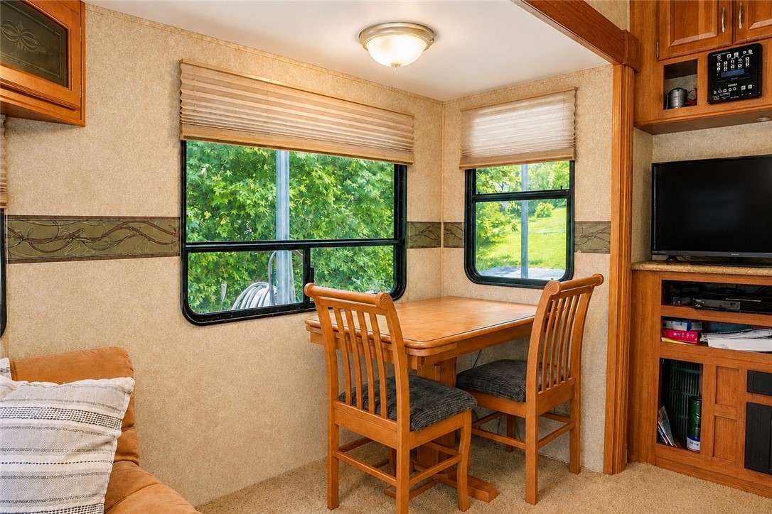 208 Reston Way Westminster, SC 29693 - Photo 5 of 26 This cozy dining area with lush outdoor views offers a comfortable spot for meals.