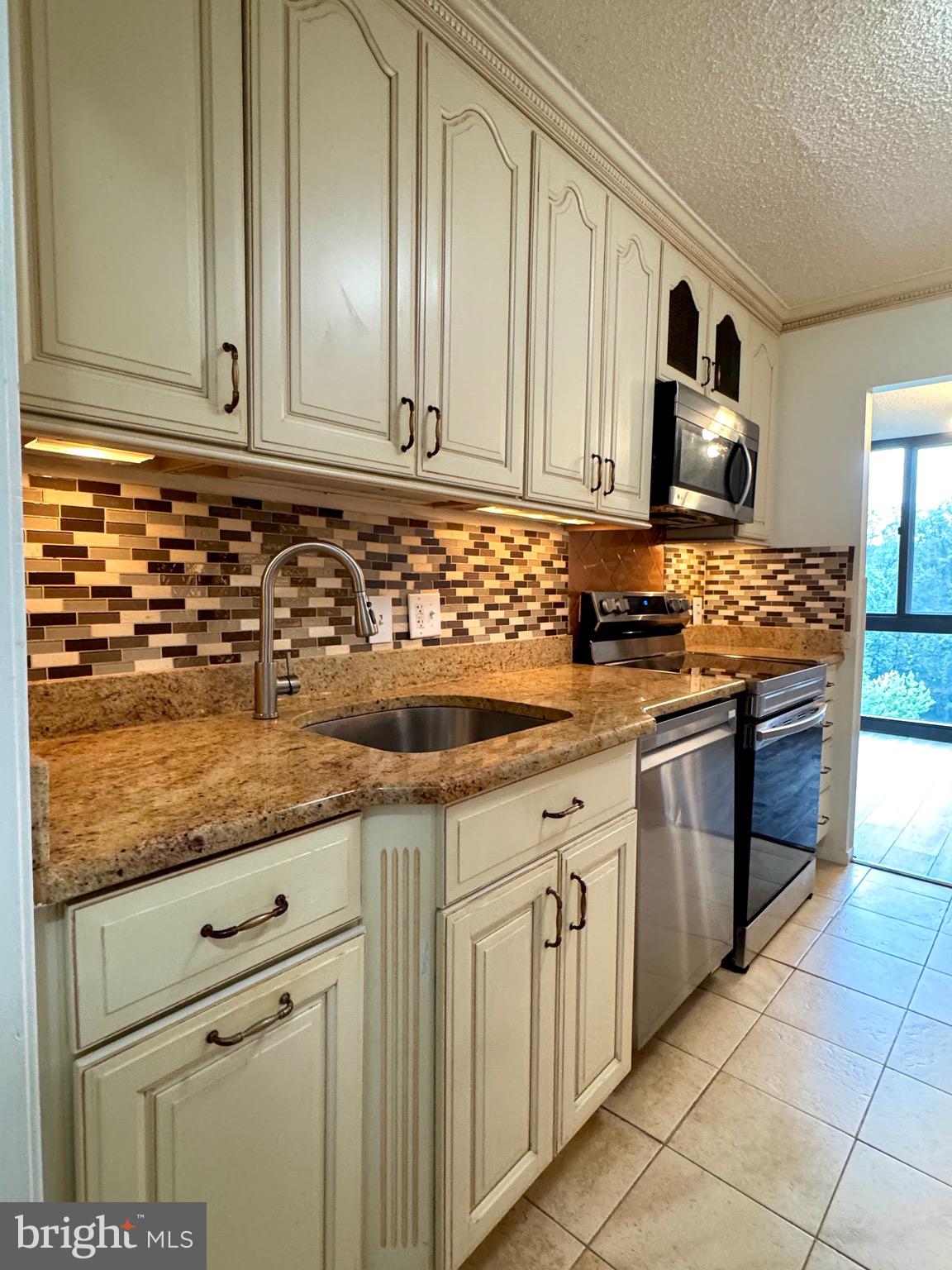 2300 Pimmit Drive, Unit 719 Falls Church, VA 22043 - Photo 1 of 15 a kitchen with stainless steel appliances granite countertop a sink stove and cabinets