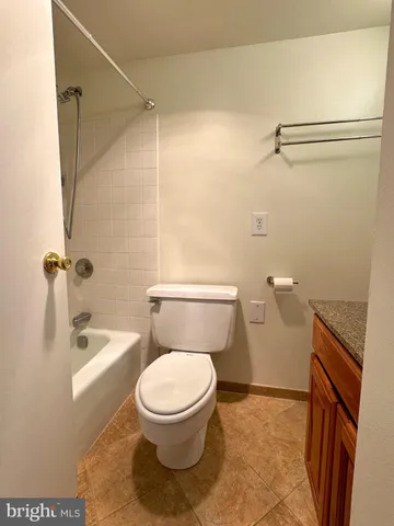 a white toilet sitting next to a bath tub