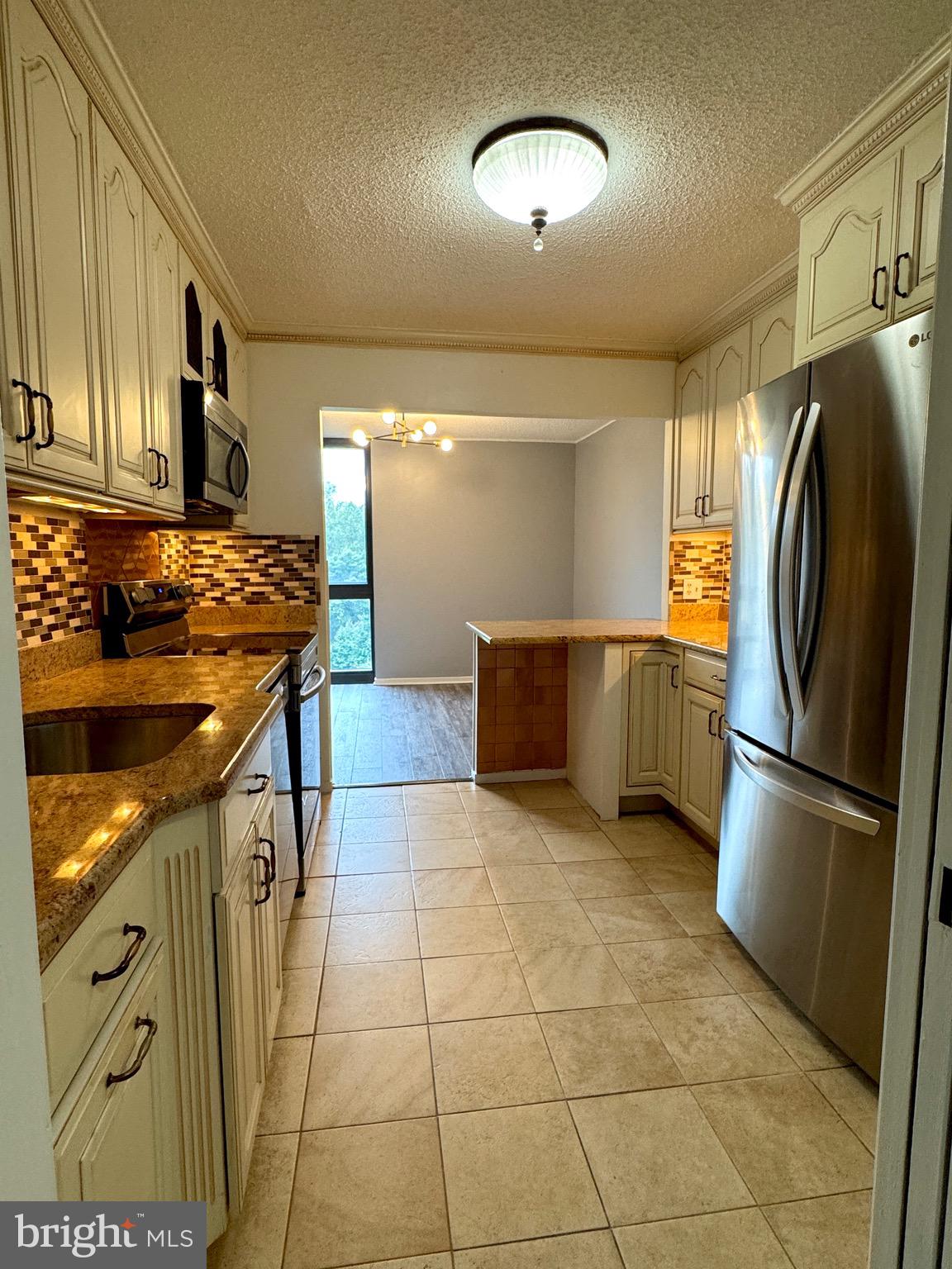 2300 Pimmit Drive, Unit 719 Falls Church, VA 22043 - Photo 5 of 15 a kitchen with stainless steel appliances granite countertop a refrigerator a stove and a sink