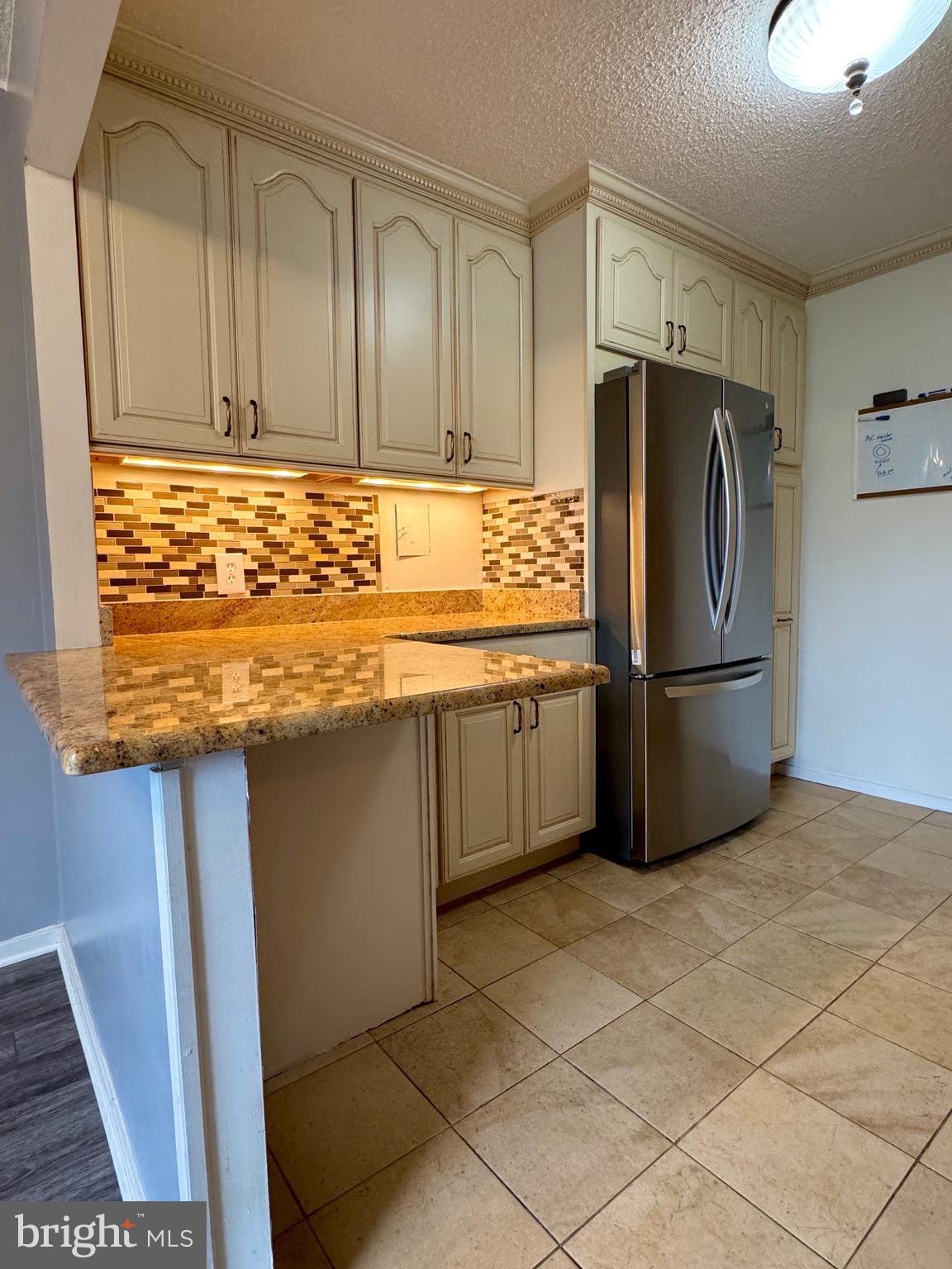 2300 Pimmit Drive, Unit 719 Falls Church, VA 22043 - Photo 7 of 15 a kitchen with stainless steel appliances granite countertop a refrigerator and a sink