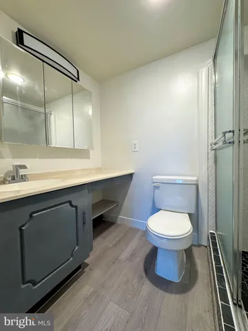 a bathroom with a sink toilet and a mirror