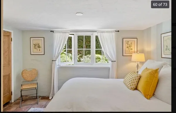 a bedroom with a large bed and a large window