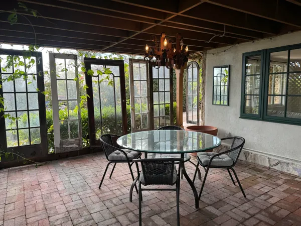 a patio with a table and chairs