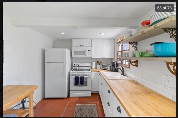 a kitchen with a sink a refrigerator and a stove