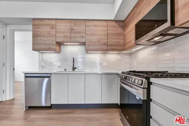 a kitchen with cabinets and wooden floor