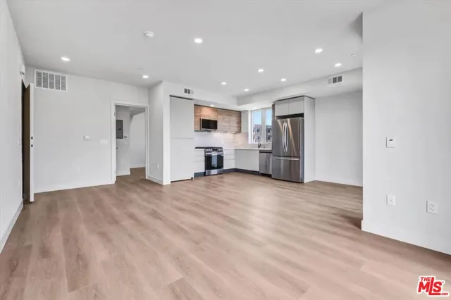 a view of kitchen with refrigerator and window