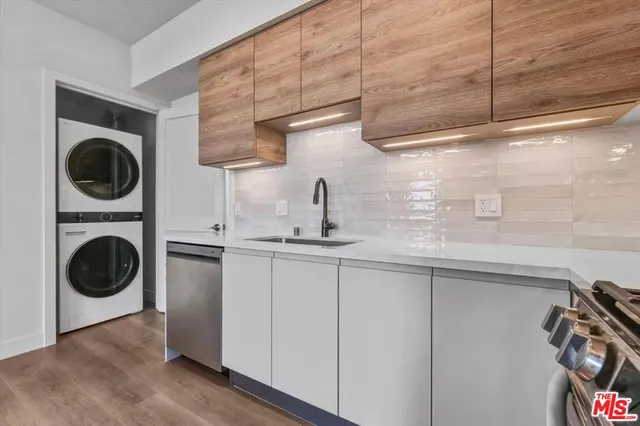 a kitchen with a sink a washer and dryer