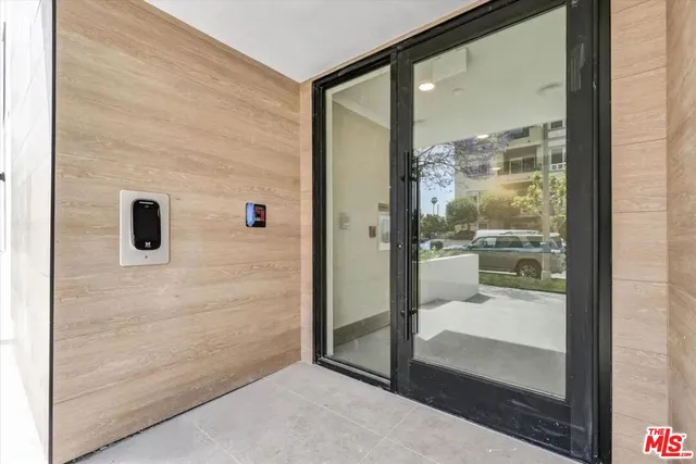 a bathroom with a glass shower door and a mirror