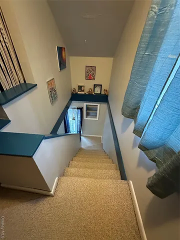 a living room with a couch and a stove with wooden floor