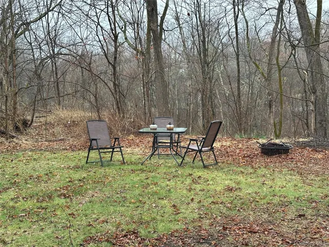 a lawn chairs sitting in a backyard of a house