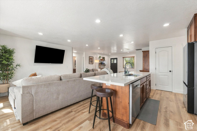 437 Scenic Heights Road Kamas, UT 84036 - Photo 12 of 46 Open-concept living space featuring wood-finish flooring, recessed lighting, and a kitchen island with seating