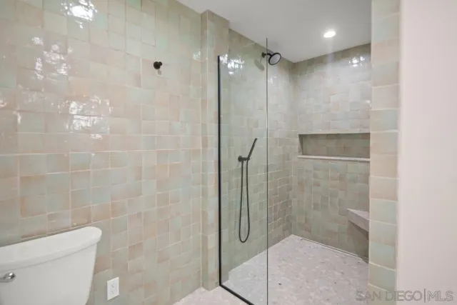 a bathroom with a shower and toilet