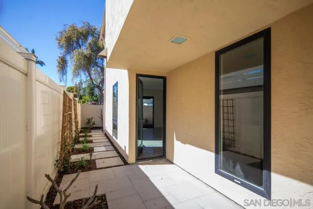 a view of a house with a potted plant windows