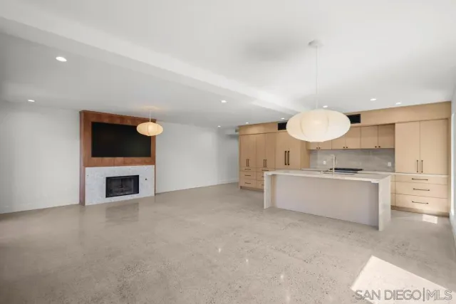 a view of a kitchen with a sink and a fireplace