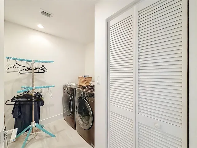 a view of a storage & utility room with a washer and dryer