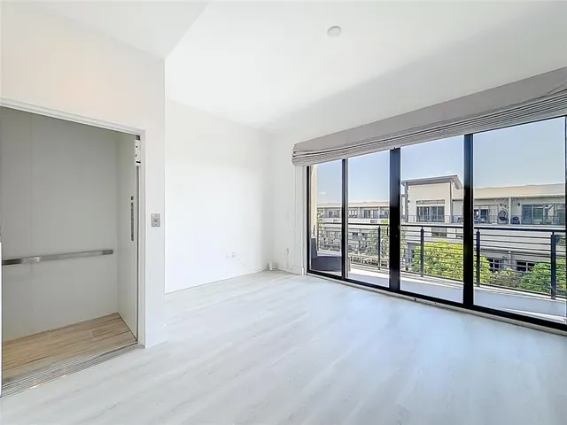 an empty room with sliding glass door and outer view