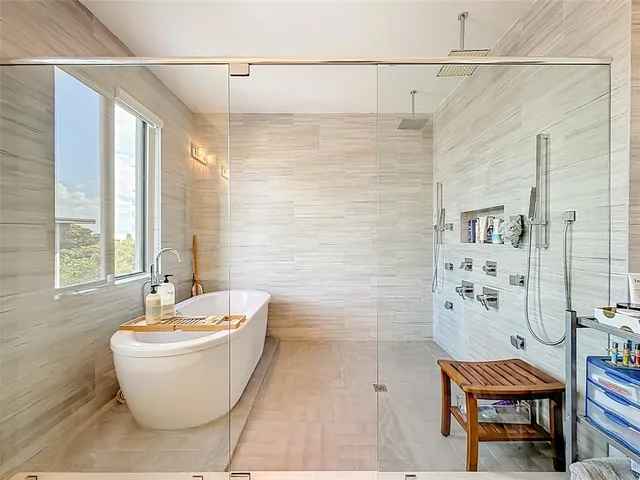 a bathroom with a bathtub and shower