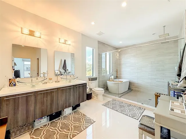 a spacious bathroom with a double vanity sink and a mirror
