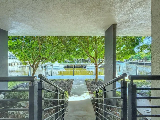 a view of a house with a small yard and tree s