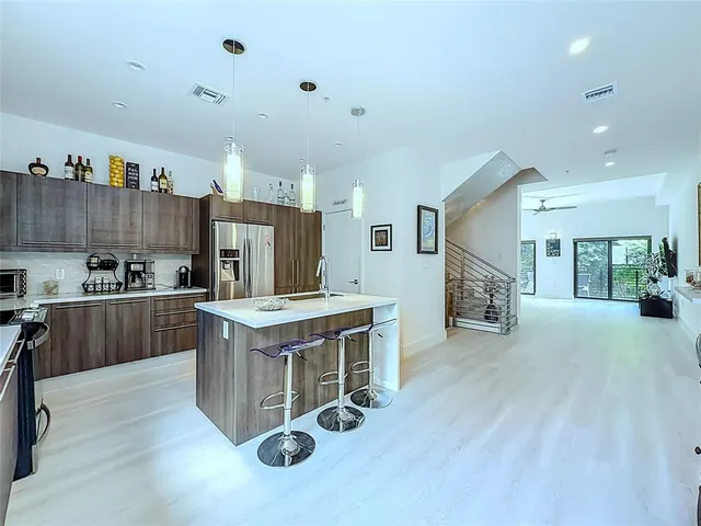 a kitchen with stainless steel appliances granite countertop a stove and a refrigerator