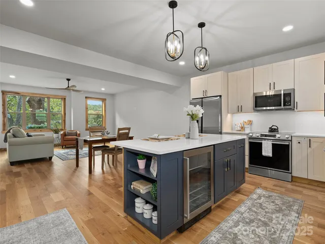 a kitchen with a stove window and chairs