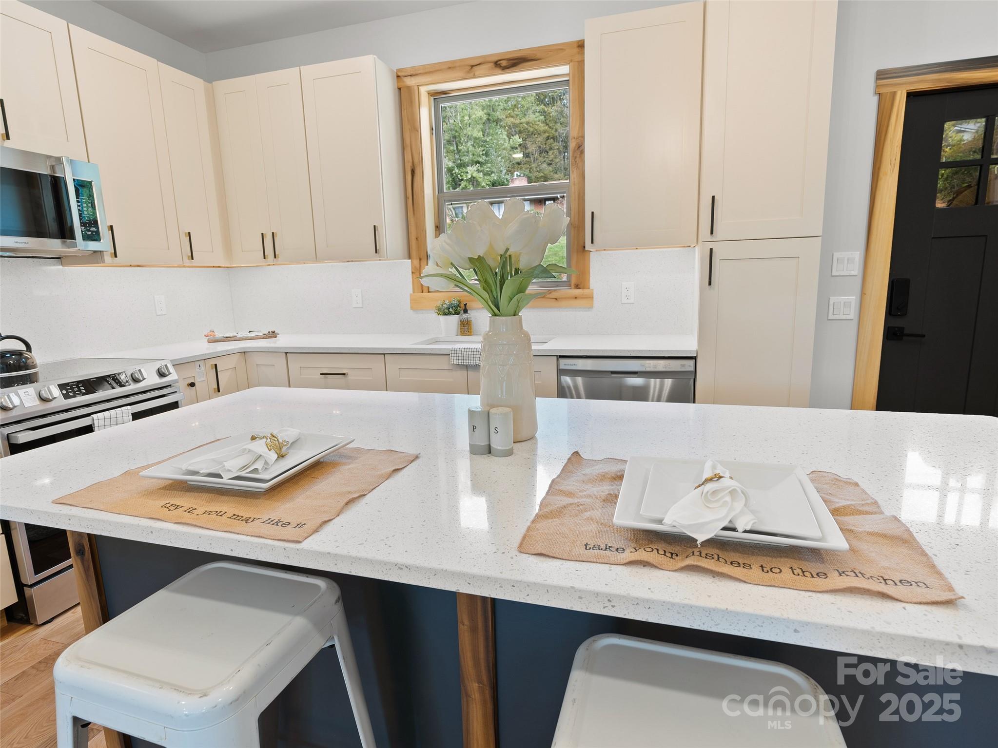 292 County Road Waynesville, NC 28785 - Photo 7 of 26 a white kitchen with a stove and a wooden floor