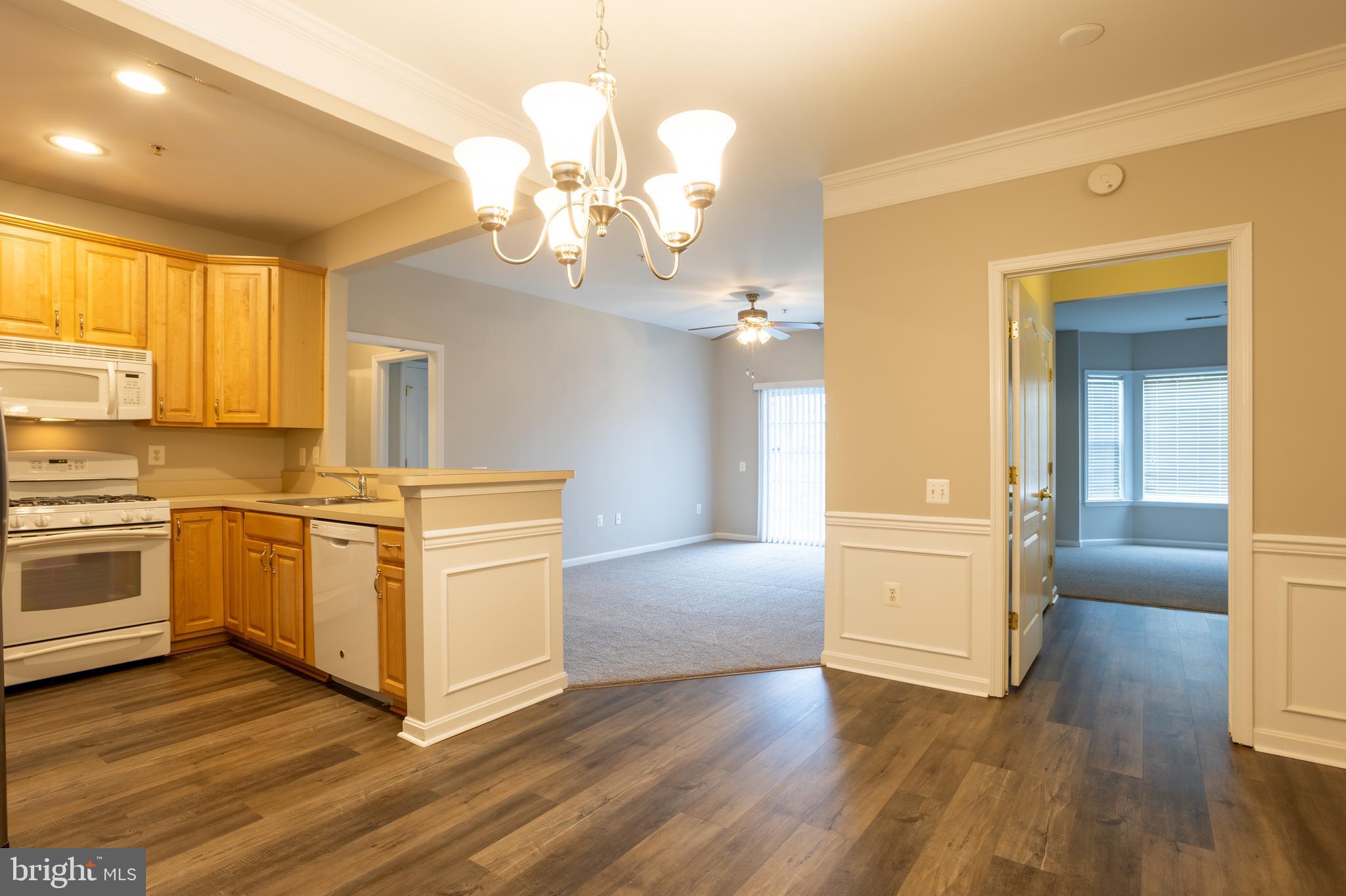 504 Lloyd Place Bel Air, MD 21014 - Photo 11 of 40 a view of a kitchen with a sink and dishwasher a stove top oven with wooden floor