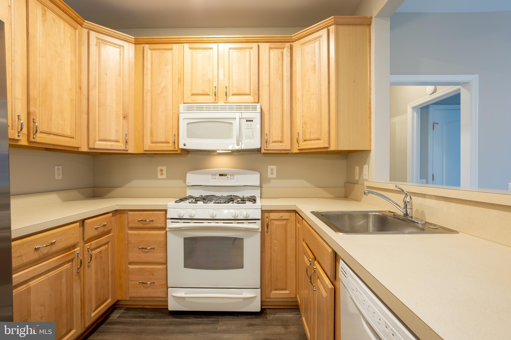 504 Lloyd Place Bel Air, MD 21014 - Photo 15 of 40 a kitchen with granite countertop white cabinets and white appliances