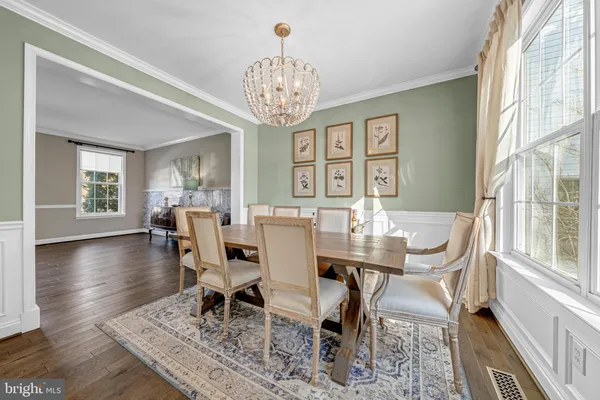 a view of a dining room with furniture wooden floor and chandelier