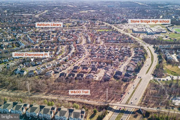 an aerial view of residential houses with city view
