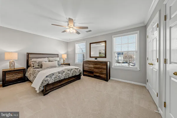 a spacious bedroom with a bed and dresser