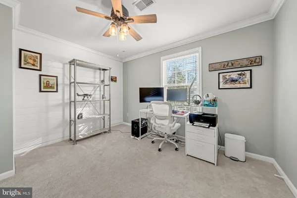 a view of a livingroom with workspace and a window