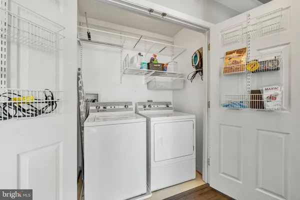 a view of washer and dryer with kitchen in the background
