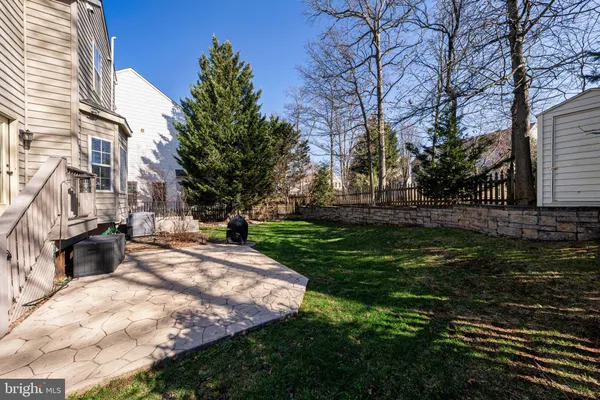a view of a yard with plants and trees