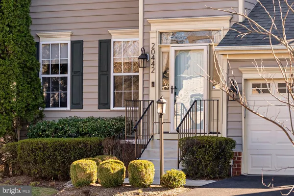 a view of a house with a chairs in porch