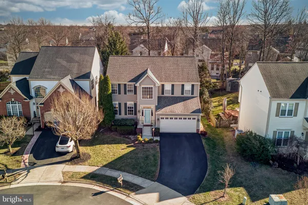 an aerial view of a house with garden space and sitting area